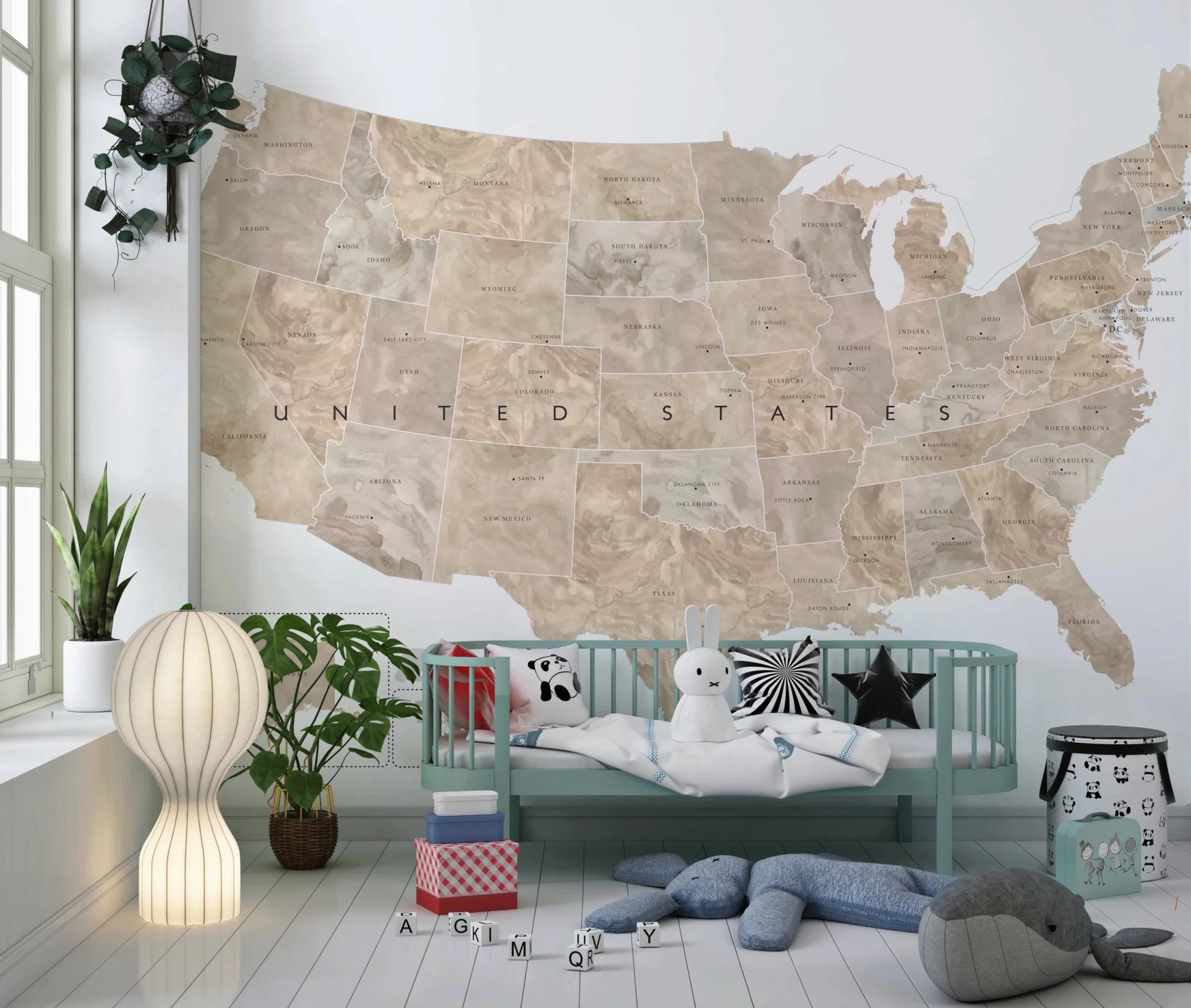 USA map with states and capitals in tan watercolor wallpaper mural in a kids room with a mint daybed and plush toys