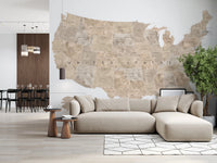 USA map with states and capitals in tan watercolor wallpaper mural behind a beige sectional sofa in a living room