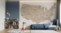 USA map with states and capitals in tan watercolor wallpaper mural in a kids bedroom with a navy bed and rocket toy