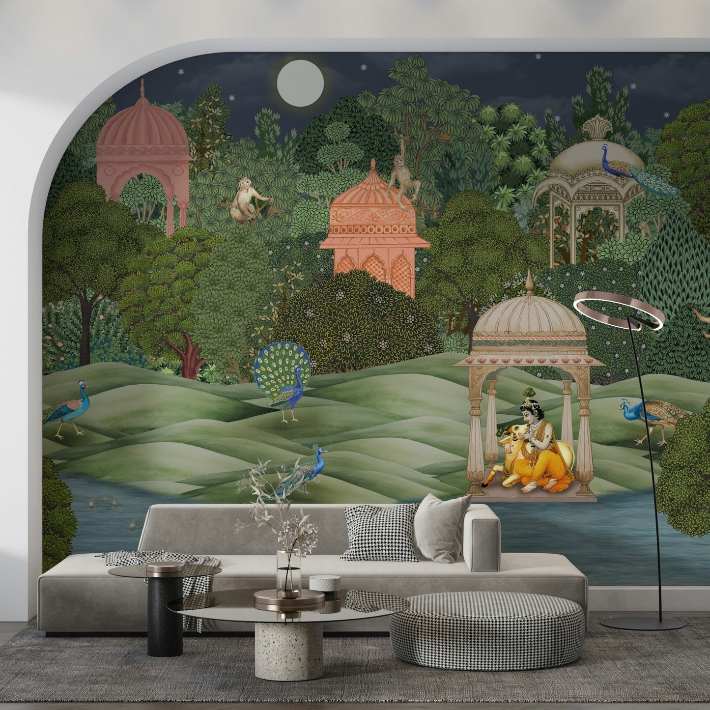 Vanara Vatika wall mural with pink garden pavilions, peacocks and Krishna behind a beige sofa in a living room