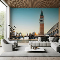 Venetian Sunrise wallpaper mural of the Venice bell tower and square above a grey sofa under a wood-slat ceiling
