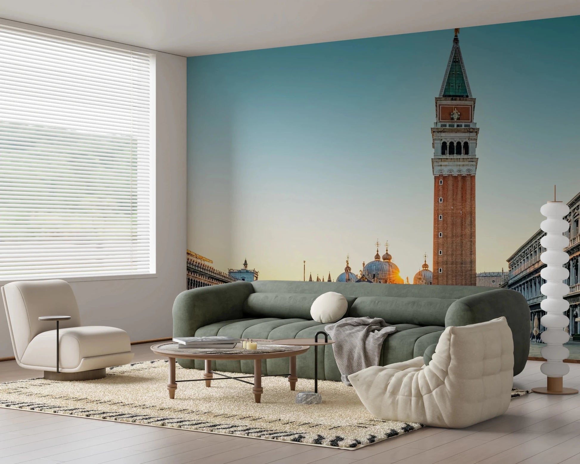 Venetian Sunrise wallpaper mural of St Mark's tower and domes above a green sofa and cream togo lounge chair