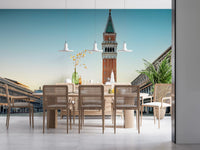 Venetian Sunrise wallpaper mural of the Venice bell tower behind a wood dining table and cane chairs