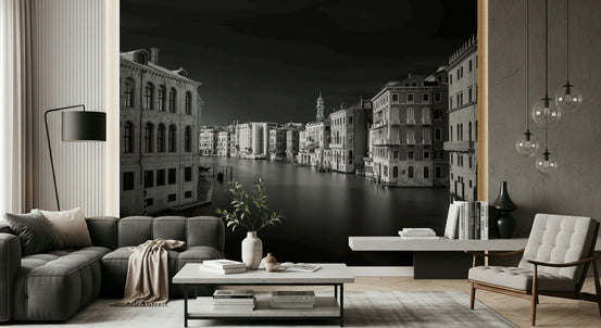 Venetian Echoes: Monochrome Serenity wallpaper mural of the black-and-white Venice Grand Canal behind a gray sectional sofa in a living room