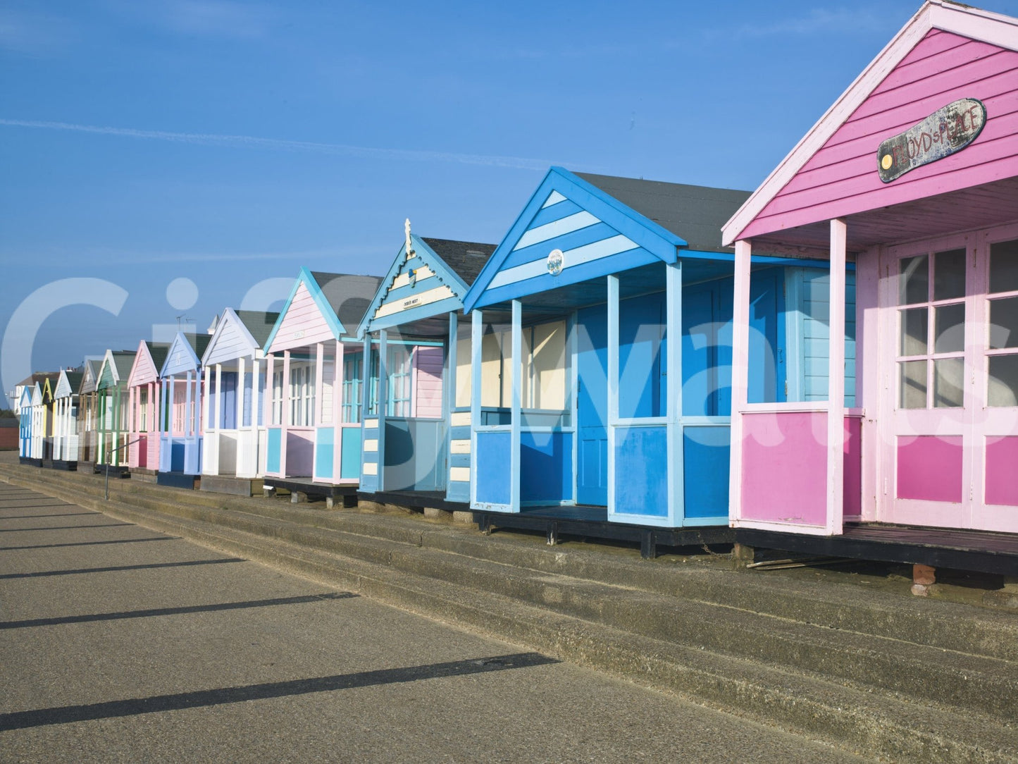 Summer seaside wall mural with colorful huts
