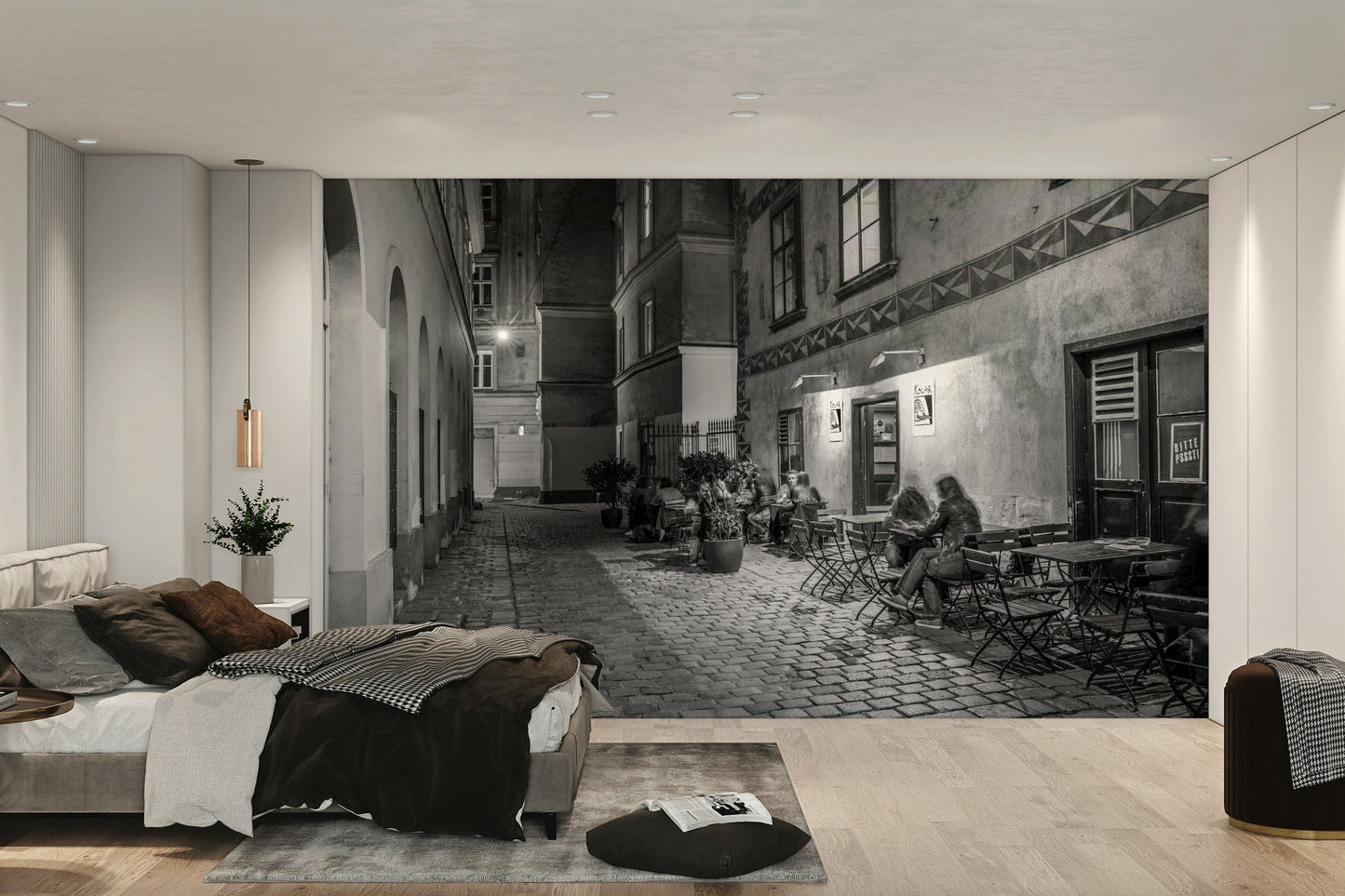 Street cafe in Vienna wallpaper mural of a black and white cobbled cafe alley behind a low grey bed in a bedroom