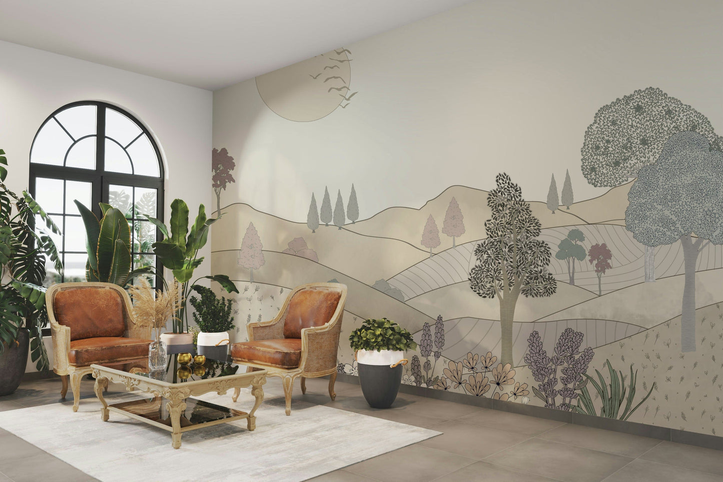 Vintage Bloomscape wallpaper mural of muted hills and trees behind tan leather armchairs in a living room