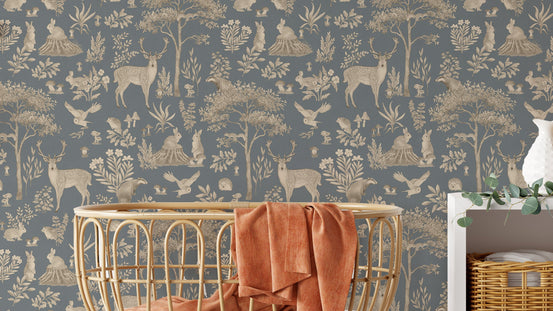 Vintage Blue Wildlife wallpaper in slate and tan behind a rattan basket chair with a rust throw