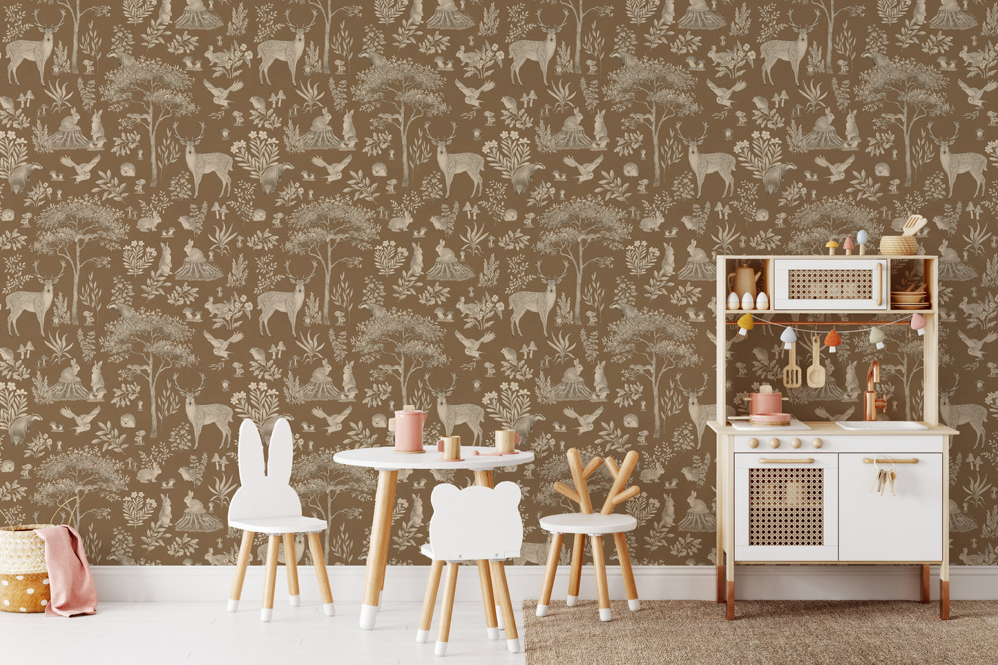 Vintage Brown Wildlife wallpaper behind a round play table, animal stools and a white rattan play kitchen