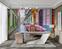 Vintage pink car parked on Havana street mural

