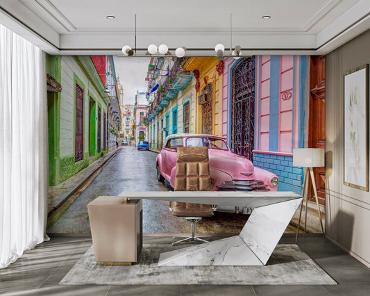 Vintage pink car parked on Havana street mural

