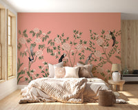 Vintage Chinoiserie Floral wallpaper mural of peach roses and birds above a cozy bed with a chunky knit throw