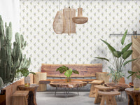 Vintage Floral Whispers wallpaper mural in a boho lounge with a live-edge wood bench, rattan pendants and cacti