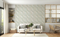 Vintage Folk Tiles Sage Green wallpaper behind a cream sofa beside built-in shelves in a bright living room