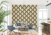 Abstract geometric wallpaper featuring repeating olive diamonds and starburst accents.