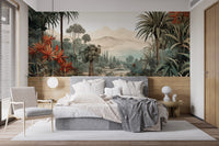 Verdant Valley Vintage Tropical Flora mural of a tropical valley behind a gray bed and rattan chair in a bedroom