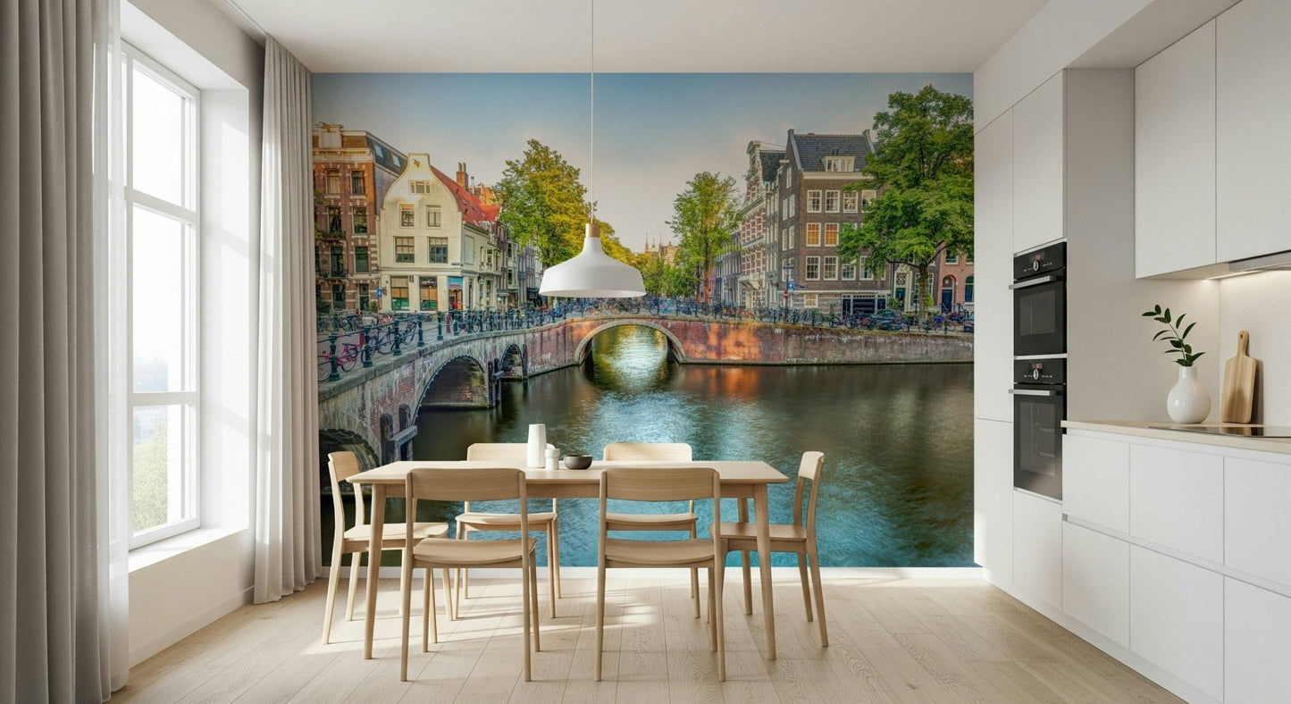 Visit Amsterdam wallpaper mural of an Amsterdam canal behind a wood dining table in a white kitchen