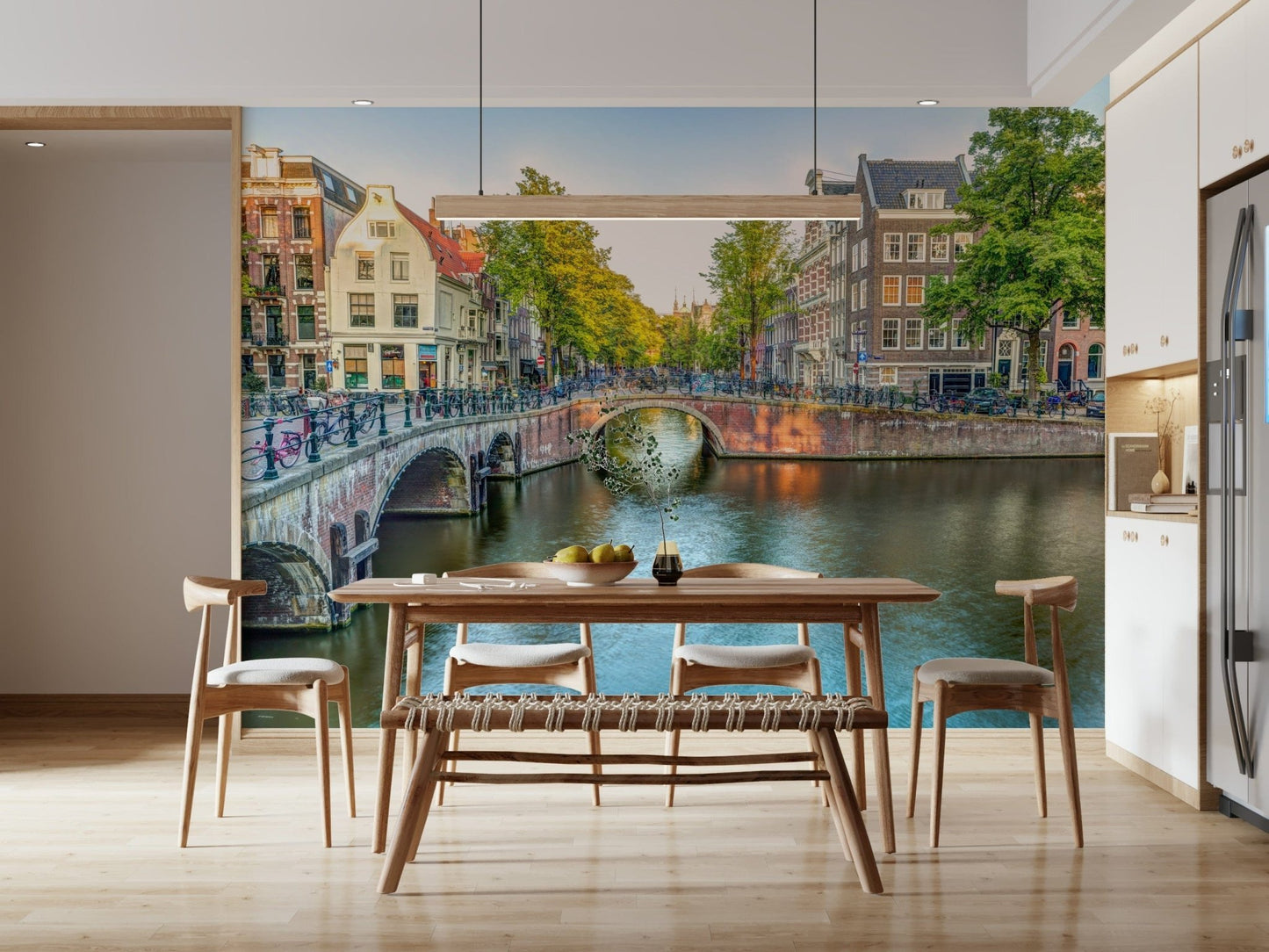 Visit Amsterdam wallpaper mural of a canal bridge behind a walnut dining table with a woven bench in a dining room
