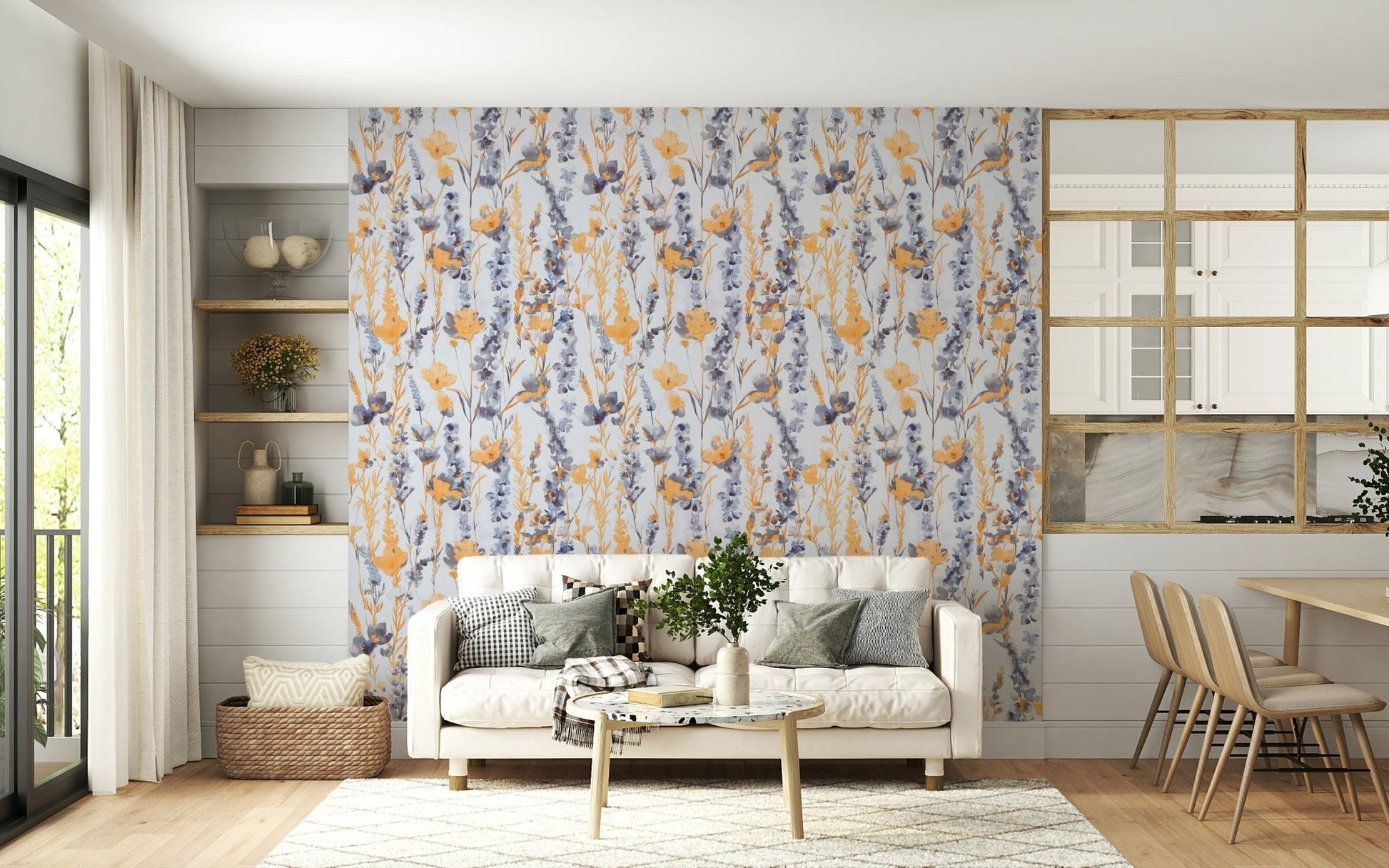 Warm Meadow Harmony wallpaper of orange and blue wildflowers behind a cream sofa in a bright living room