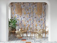 Warm Meadow Harmony wallpaper of amber and blue wildflowers in a tiled cafe with rattan chairs and pendants