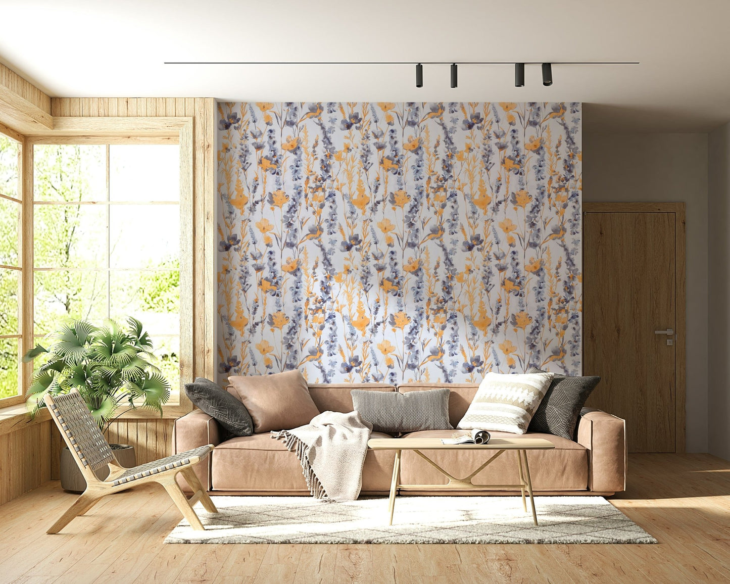 Warm Meadow Harmony wallpaper of amber and blue wildflowers behind a tan sofa in a sunlit wood-trimmed room