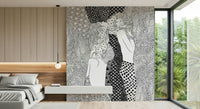 Water Serpents wallpaper mural of two line-art women behind a low gray platform bed in a modern bedroom