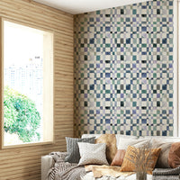 Blue checkerboard mural with artistic, hand-painted squares.

