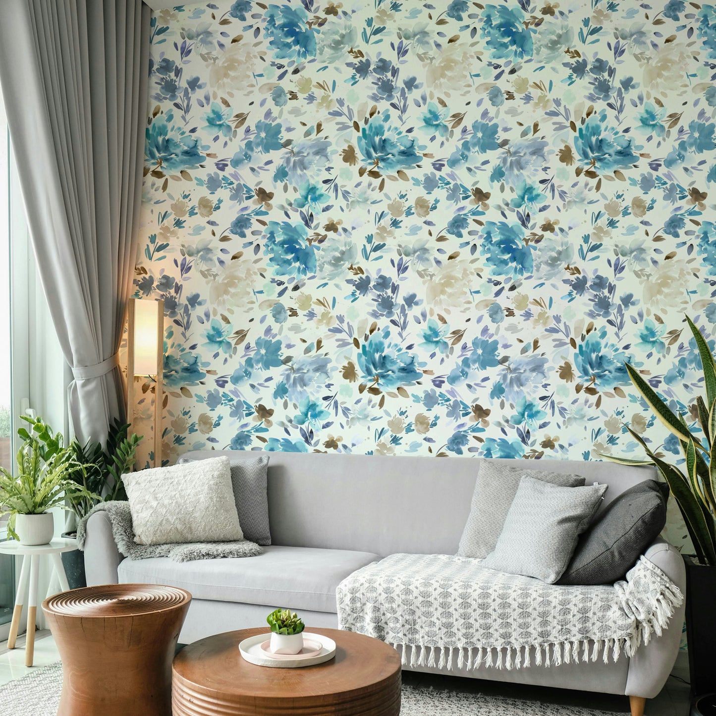 Wallpaper with elegant blue florals and natural leaf accents.

