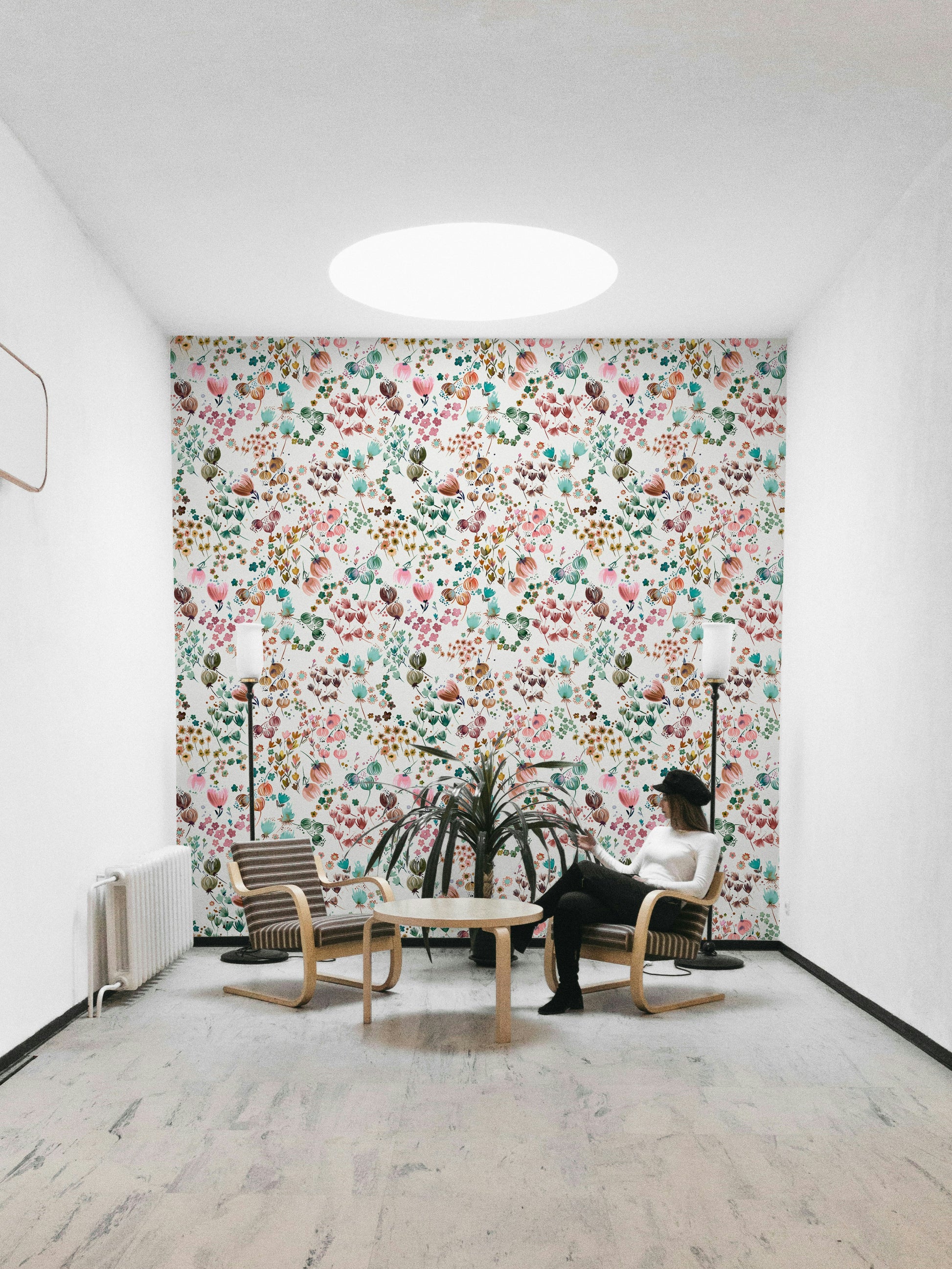 Floral mural featuring green leaves and orange flower buds.

