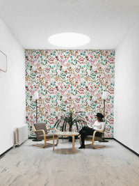 Floral mural featuring green leaves and orange flower buds.

