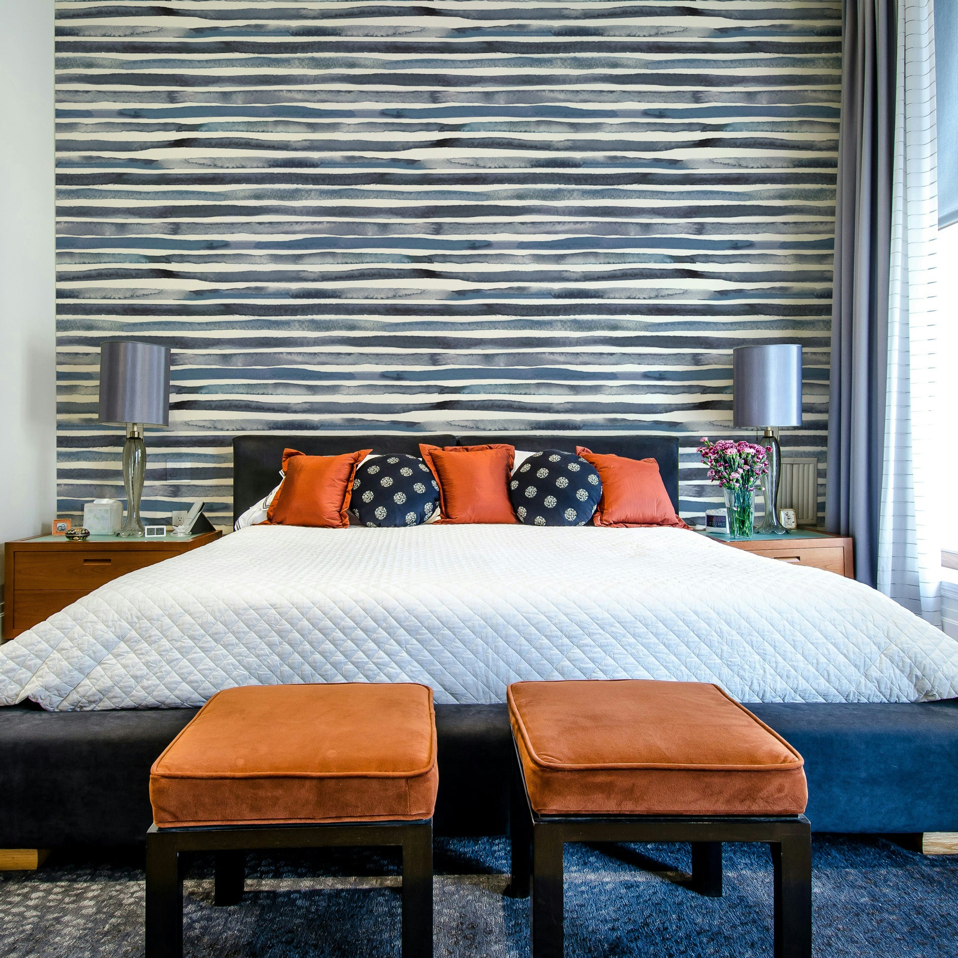 Wallpaper featuring soft blue and white watercolor stripes.

