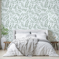 Various types of green leaves fill the spaces between the flowers.
