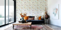 Ethereal butterfly wallpaper for walls showcasing pale pink daisies and bluebells.