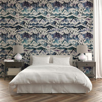Wallpaper with misty mountain ranges in soft watercolor layers.

