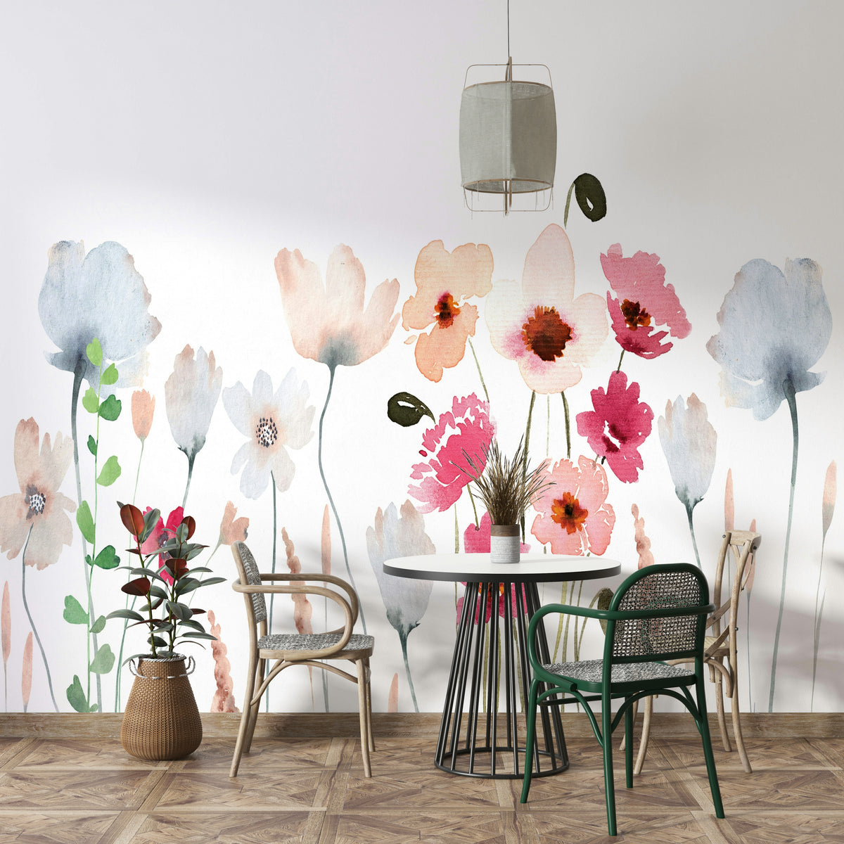 Watercolor Wildflower wallpaper mural in pink and blue blooms behind a round table with cane chairs in a dining room