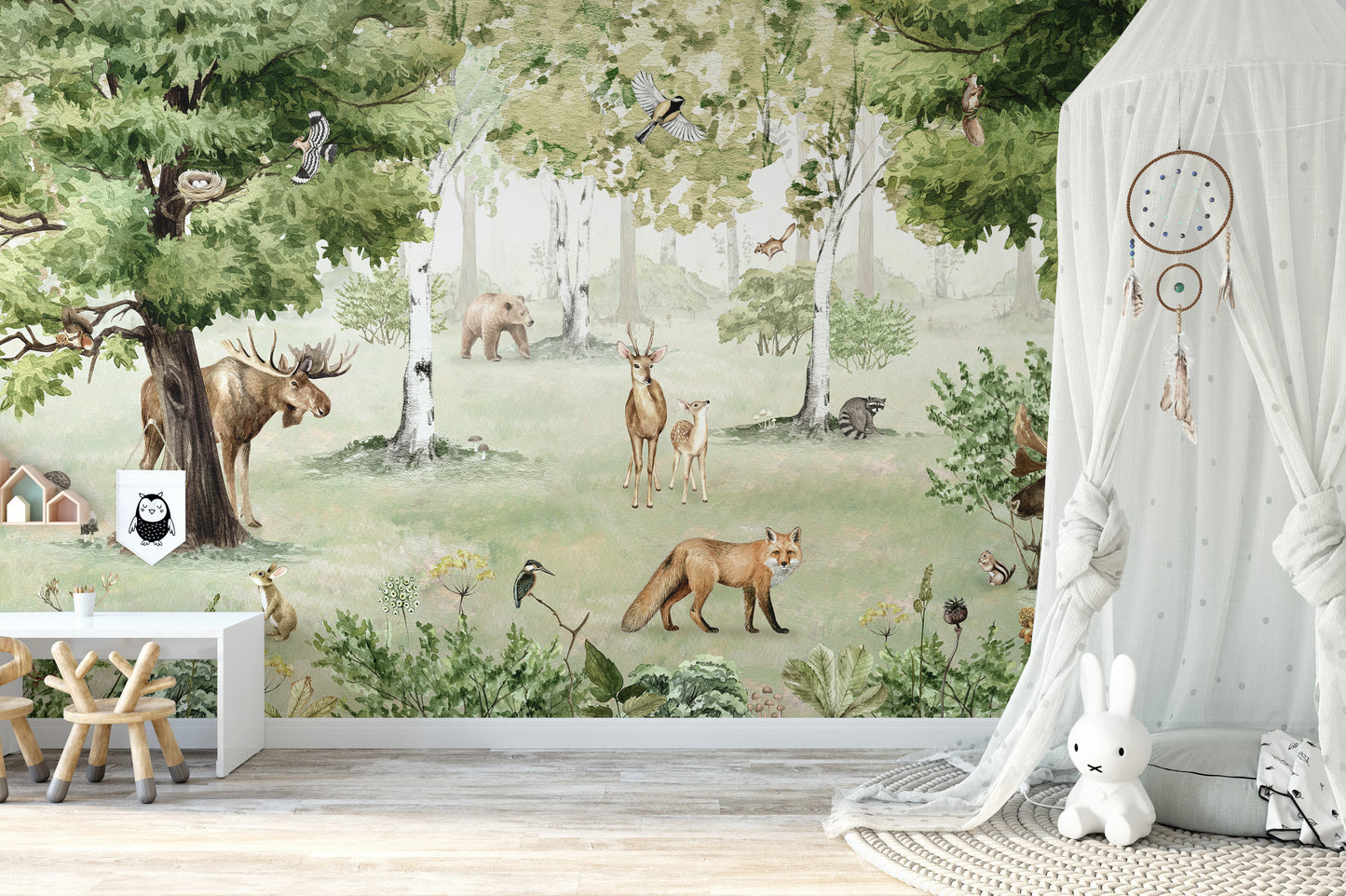Watercolor Woodland Wonders wallpaper mural with a fox and deer beside a white canopy drape and plush bunny in a nursery