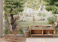Watercolor Woodland Wonders wallpaper mural of moose and deer in a forest behind a rattan hanging chair and wood console
