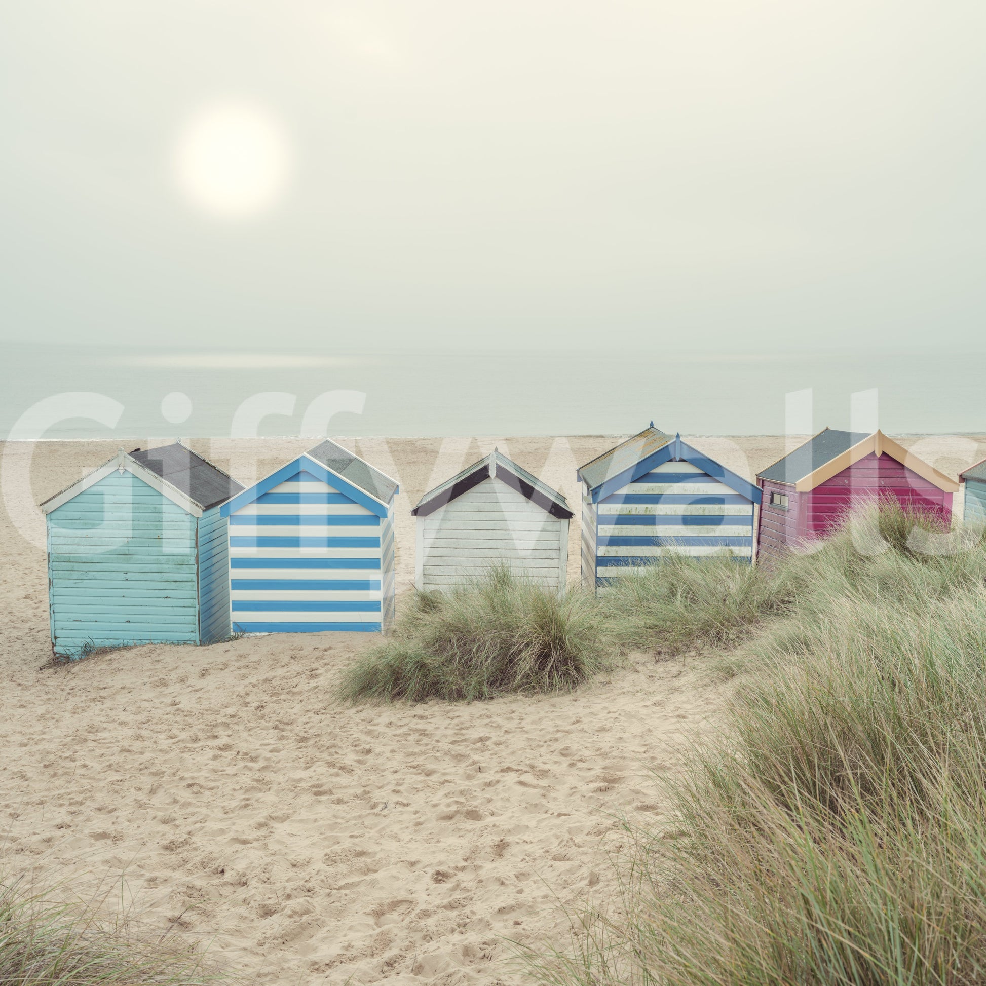 A detail of the warm tones in the beach huts and sky.

