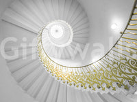 A dining area with the spiral staircase wall mural as a focal point.

