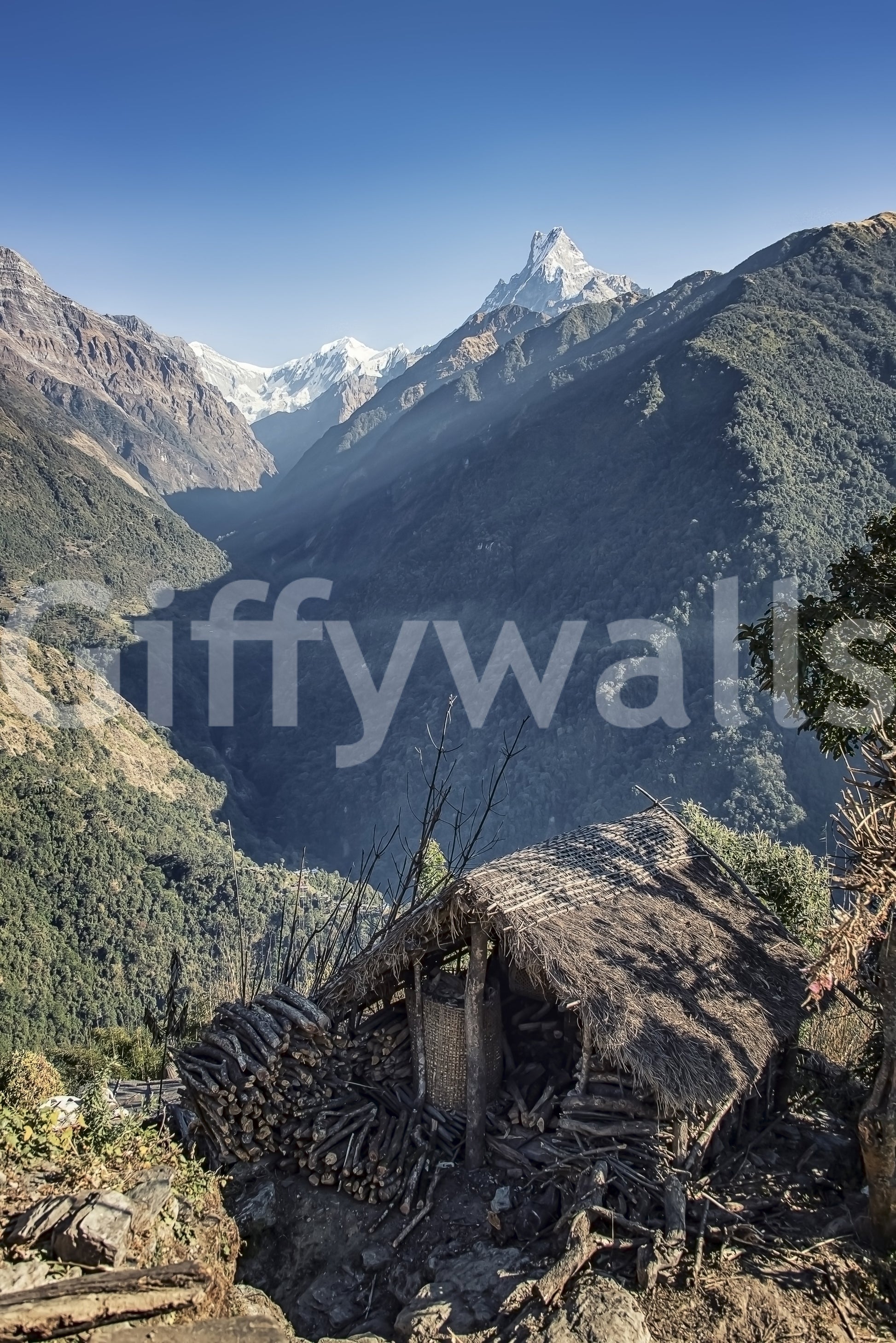 Travel-inspired wall mural featuring a remote hut and breathtaking mountainous terrain.