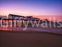 The pier stretches in soft silhouette on this Sunset Reverie wall mural.
