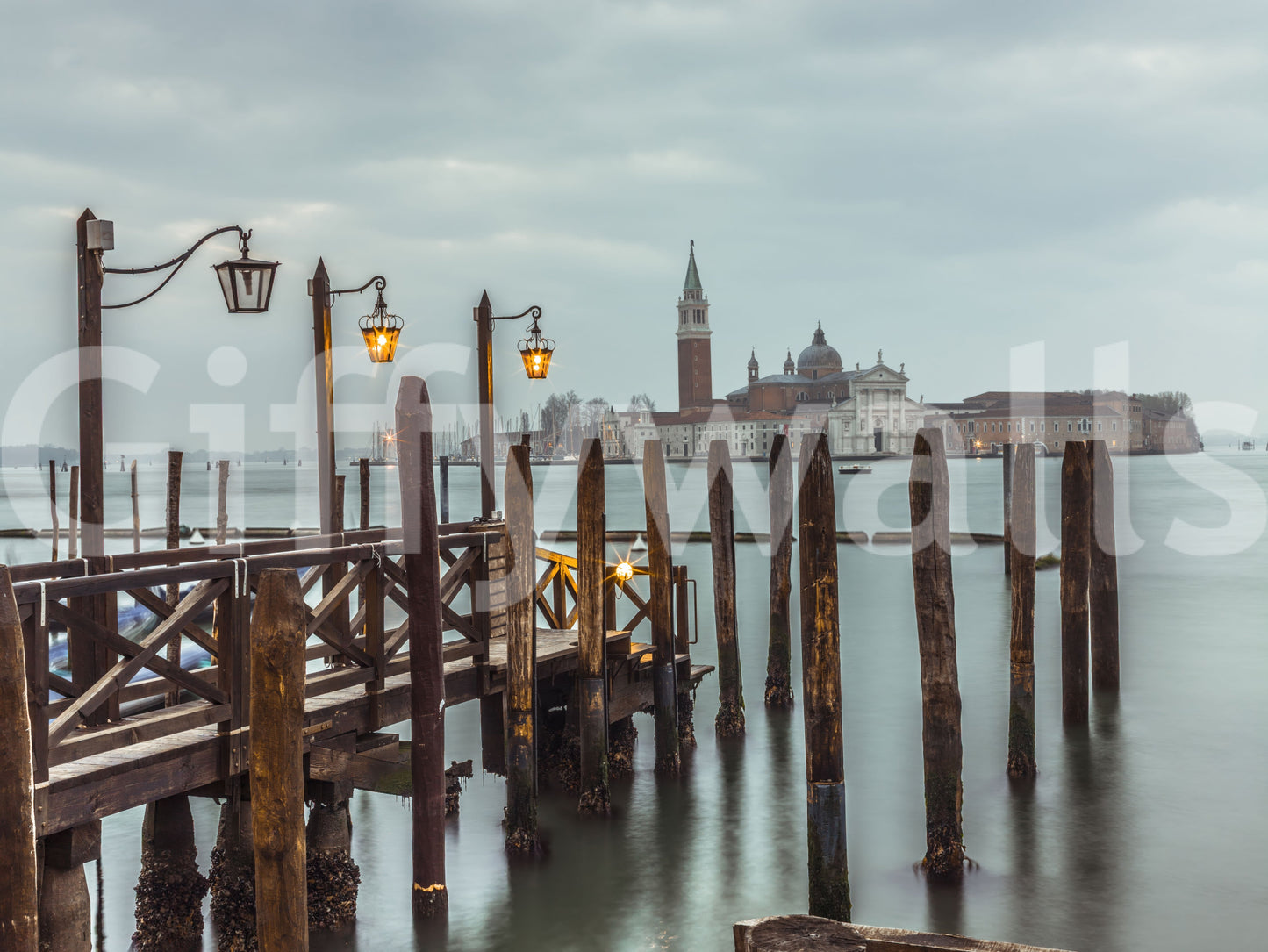 Yellow lantern glow contrasts cool grey sky in this Twilight Pier wall mural