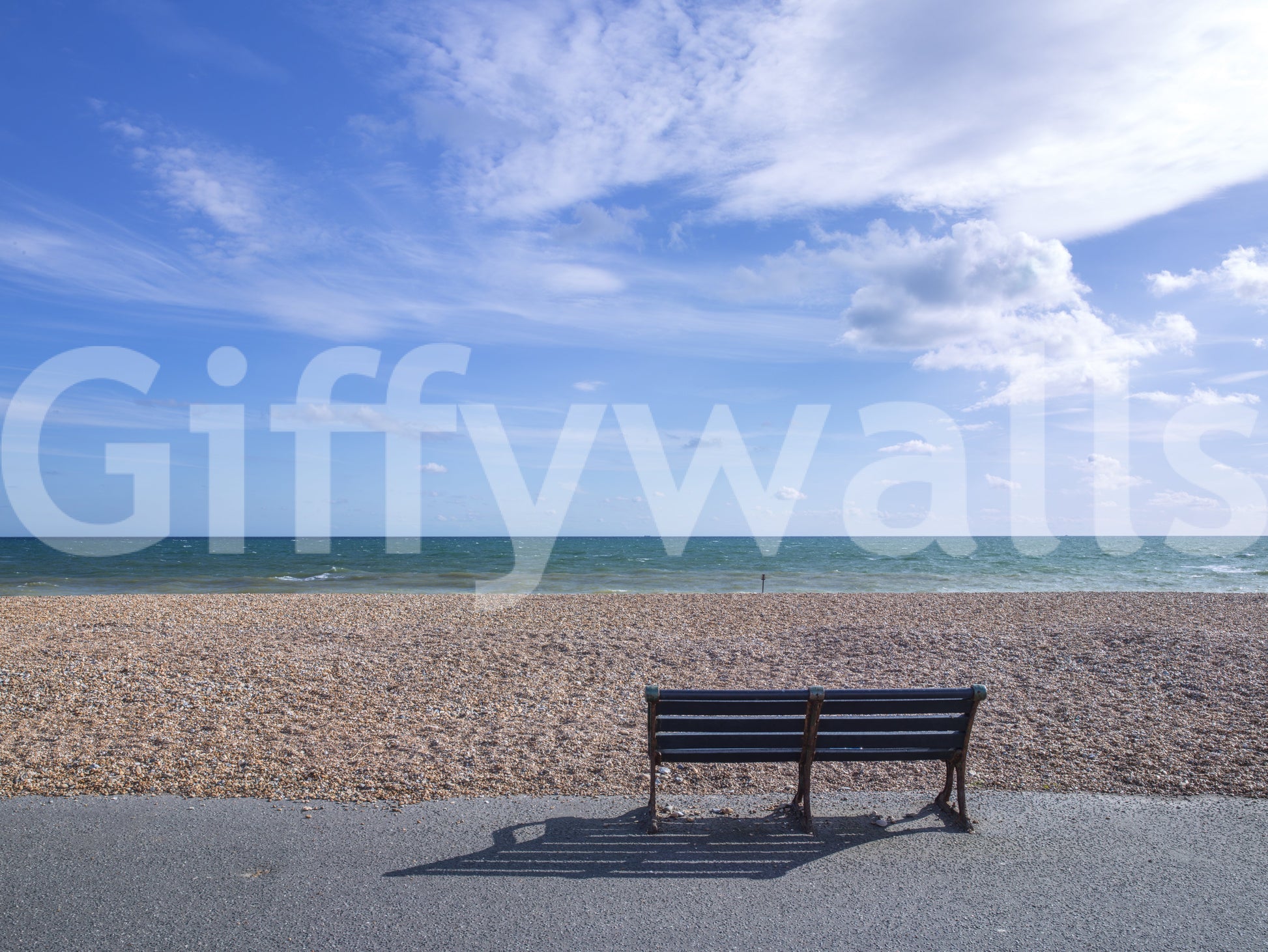 Peaceful seaside layout of the Blue Escape wall mural with white cloud bands