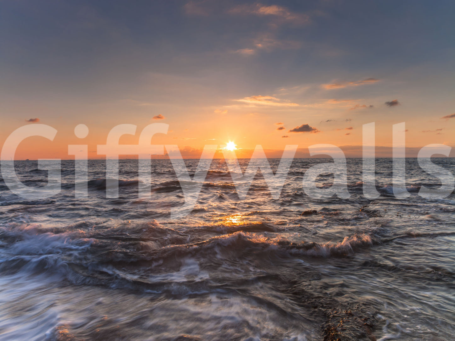 Sundown glow over moving water runs the length of this ocean wall mural