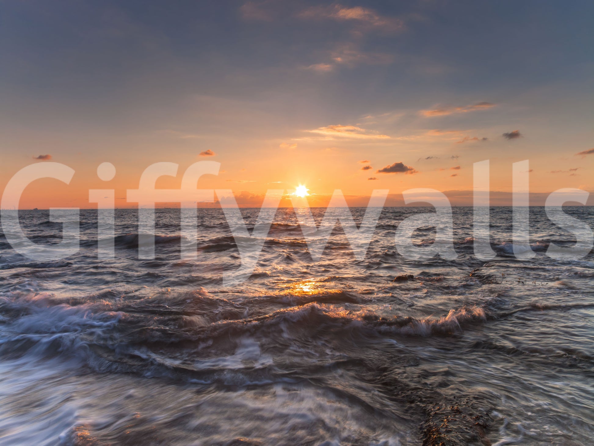 Sundown glow over moving water runs the length of this ocean wall mural