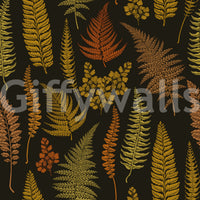 A black ground holds amber, ochre and olive fronds across this fern wallpaper