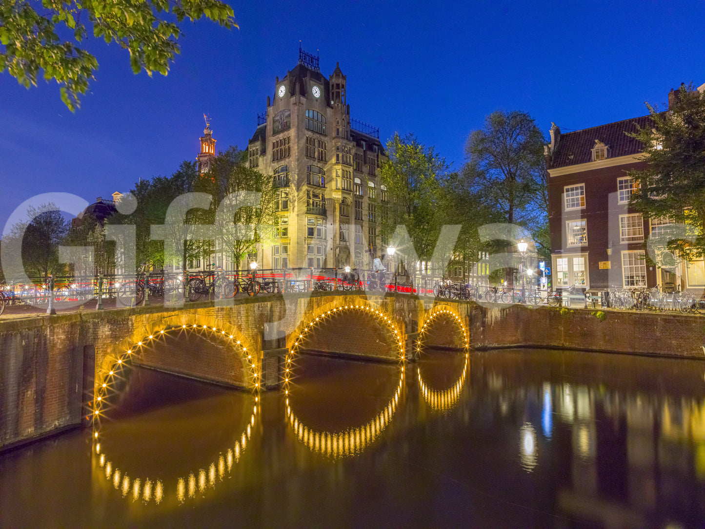 Canal through Amsterdam city Wall Mural