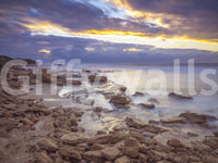 Close-up of beach wallpaper swatch with brown rocks, silky water and gold clouds GD14207