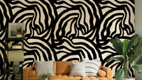 The image features abstract, wavy black lines that run vertically across the wall.
