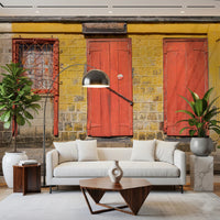 Architectural photography of a vibrant yellow wall mural with red doors